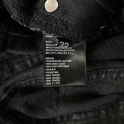 AMIRI VARSITY LOGO REPAIR JEANS